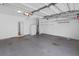 Spacious garage with a gray floor, white walls, storage shelves and door to the house at 2224 Snug Ne Hbr, Marietta, GA 30066