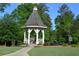 Community gazebo sits beside a pond and is surrounded by lush landscaping at 2224 Snug Ne Hbr, Marietta, GA 30066