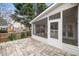 A covered patio has a stone floor, white trim, and a view of the back yard at 2224 Snug Ne Hbr, Marietta, GA 30066