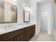 Modern bathroom featuring a double sink vanity, quartz countertop, and wood-framed mirrors at 2531 High Brow St # 41, Duluth, GA 30096