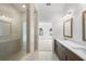 Bathroom showcasing a double vanity, tiled walk-in shower with glass, and stylish lighting at 2531 High Brow St # 41, Duluth, GA 30096
