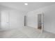 Bright bedroom featuring neutral carpet, white walls and trim, and multiple doors at 2531 High Brow St # 41, Duluth, GA 30096