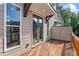 A spacious wooden deck with a beige siding home, features glass windows, and an outdoor living space at 2531 High Brow St # 41, Duluth, GA 30096