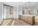 Modern kitchen with a large island, stainless steel appliances, and light wood flooring at 2531 High Brow St # 41, Duluth, GA 30096