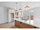 Bright kitchen with quartz island, pendant lighting, stainless appliances, and deck access at 2531 High Brow St # 41, Duluth, GA 30096
