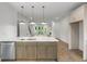 Open-concept kitchen with large island, stainless steel appliances, and wood-grain vinyl flooring at 2531 High Brow St # 41, Duluth, GA 30096