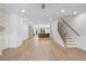 Spacious, airy living area flows into kitchen, featuring hardwood floors and stairs at 2531 High Brow St # 41, Duluth, GA 30096
