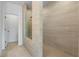 Walk-in shower featuring beige horizontal tiles, and a glass divider and door at 2531 High Brow St # 41, Duluth, GA 30096