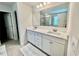 Bathroom featuring a double vanity, sleek countertops, and a large mirror creating a bright and open space at 339 Garnet Dr, Acworth, GA 30101