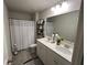 Bathroom featuring a double vanity with white cabinets, a shower with a tub, and tile flooring at 339 Garnet Dr, Acworth, GA 30101