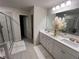 Bright bathroom featuring a double vanity with white cabinets, a walk-in shower, and tile flooring at 339 Garnet Dr, Acworth, GA 30101