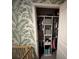 Organized closet with shelving and hanging space, featuring stylish wallpaper at 339 Garnet Dr, Acworth, GA 30101