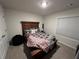 Cozy bedroom featuring a wood bed frame, a ceiling light, carpet, and a dresser for storage at 339 Garnet Dr, Acworth, GA 30101