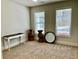 An empty bedroom with neutral carpeting features a window and decorative elements at 339 Garnet Dr, Acworth, GA 30101