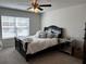 Bedroom featuring neutral carpet, modern fan and furnishings, and a bright, airy atmosphere at 339 Garnet Dr, Acworth, GA 30101