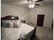 Cozy bedroom featuring a dark wood bed frame, a ceiling fan, carpet, and a dresser for storage at 339 Garnet Dr, Acworth, GA 30101