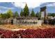 Stone monument sign at the Wildbrooke community entrance with colorful flowers and water features at 339 Garnet Dr, Acworth, GA 30101