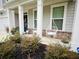 Charming front porch with hanging swing chairs and beautiful landscaping at 339 Garnet Dr, Acworth, GA 30101