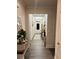 Inviting hallway featuring wood floors, decorative mirrors, dresser, rug, and updated lighting fixture at 339 Garnet Dr, Acworth, GA 30101