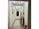 Inviting hallway featuring wood floors, decorative mirrors, dresser, rug, and updated lighting fixture at 339 Garnet Dr, Acworth, GA 30101