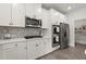 A modern kitchen featuring sleek white cabinets, stainless steel appliances, and wooden floors at 339 Garnet Dr, Acworth, GA 30101