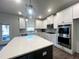 Modern kitchen featuring stainless steel appliances and an island with quartz countertops at 339 Garnet Dr, Acworth, GA 30101