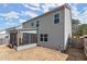 Rear exterior view of a two-story home showcasing the screened porch and backyard at 339 Garnet Dr, Acworth, GA 30101