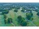 Aerial view of a golf course community with houses and lush green landscape at 3795 Greenside Ct, Dacula, GA 30019