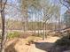 Landscaped backyard with mature trees and golf course view at 3795 Greenside Ct, Dacula, GA 30019