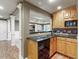 Basement bar with granite countertop, wood cabinets, and dishwasher at 3795 Greenside Ct, Dacula, GA 30019