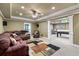 Spacious basement recreation room with leather furniture and rug at 3795 Greenside Ct, Dacula, GA 30019