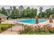 Community pool with lounge chairs, umbrellas, and a waterslide at 3795 Greenside Ct, Dacula, GA 30019