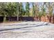 Well-maintained backyard with gravel, trees, and a wooden fence at 536 Moreland Ne Ave, Atlanta, GA 30307