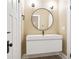 Bright bathroom with a modern sink, round mirror, and decorative floor at 536 Moreland Ne Ave, Atlanta, GA 30307