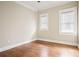 Bright bedroom with hardwood floors, neutral paint, and two windows at 536 Moreland Ne Ave, Atlanta, GA 30307