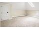 Bright bedroom features neutral carpet, white trim, angled ceiling, and a skylight window at 536 Moreland Ne Ave, Atlanta, GA 30307