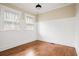 Sunlit bedroom with hardwood floors, wainscotting, neutral paint, and bright windows at 536 Moreland Ne Ave, Atlanta, GA 30307