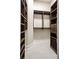 Walk-in closet with custom dark wood shelving and ample storage space at 536 Moreland Ne Ave, Atlanta, GA 30307