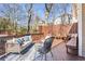 Outdoor deck features seating, stylish outdoor rug, and a view of surrounding trees at 536 Moreland Ne Ave, Atlanta, GA 30307