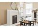 Dining room featuring glass table with seating for six, a fireplace, a round mirror, and a rug at 536 Moreland Ne Ave, Atlanta, GA 30307