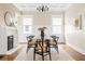 Formal dining room featuring glass table with seating for six, a fireplace, wainscotting, and a decorative rug at 536 Moreland Ne Ave, Atlanta, GA 30307