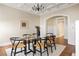 Dining room featuring glass table with seating for six, a decorative rug, and an arched doorway to the hallway at 536 Moreland Ne Ave, Atlanta, GA 30307