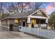 Inviting craftsman-style home with a front porch, stone accents, and a white picket fence at 536 Moreland Ne Ave, Atlanta, GA 30307