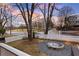 View of landscaped front yard with circular fire pit at 536 Moreland Ne Ave, Atlanta, GA 30307