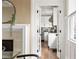 View through french doors of kitchen with stainless steel appliances, white cabinets, and stone counter tops at 536 Moreland Ne Ave, Atlanta, GA 30307