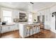 Beautiful white kitchen with modern appliances, granite counters, and an island with barstool seating at 536 Moreland Ne Ave, Atlanta, GA 30307