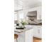 Modern kitchen with stainless steel range hood, white cabinets, and granite counters at 536 Moreland Ne Ave, Atlanta, GA 30307