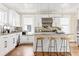 Bright, renovated kitchen with white cabinets, granite countertops and a breakfast bar with modern seating at 536 Moreland Ne Ave, Atlanta, GA 30307