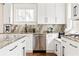 Bright kitchen features white cabinets, stainless steel appliances, marble countertops and backsplash, and a window seat at 536 Moreland Ne Ave, Atlanta, GA 30307