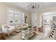 Inviting living room featuring a coffered ceiling, modern light fixture, and open access to the well-lit kitchen at 536 Moreland Ne Ave, Atlanta, GA 30307